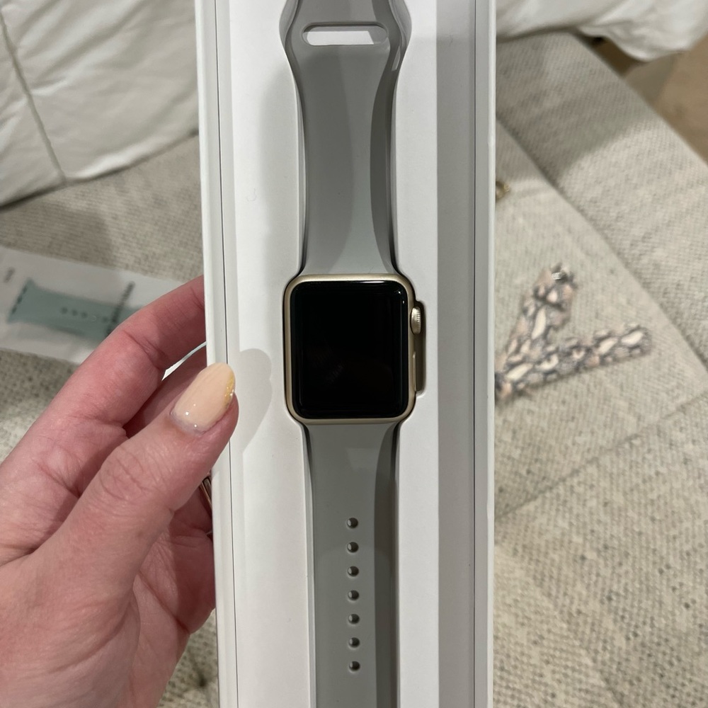 Apple Watch Series 1. Gold trim, with 5 bands.